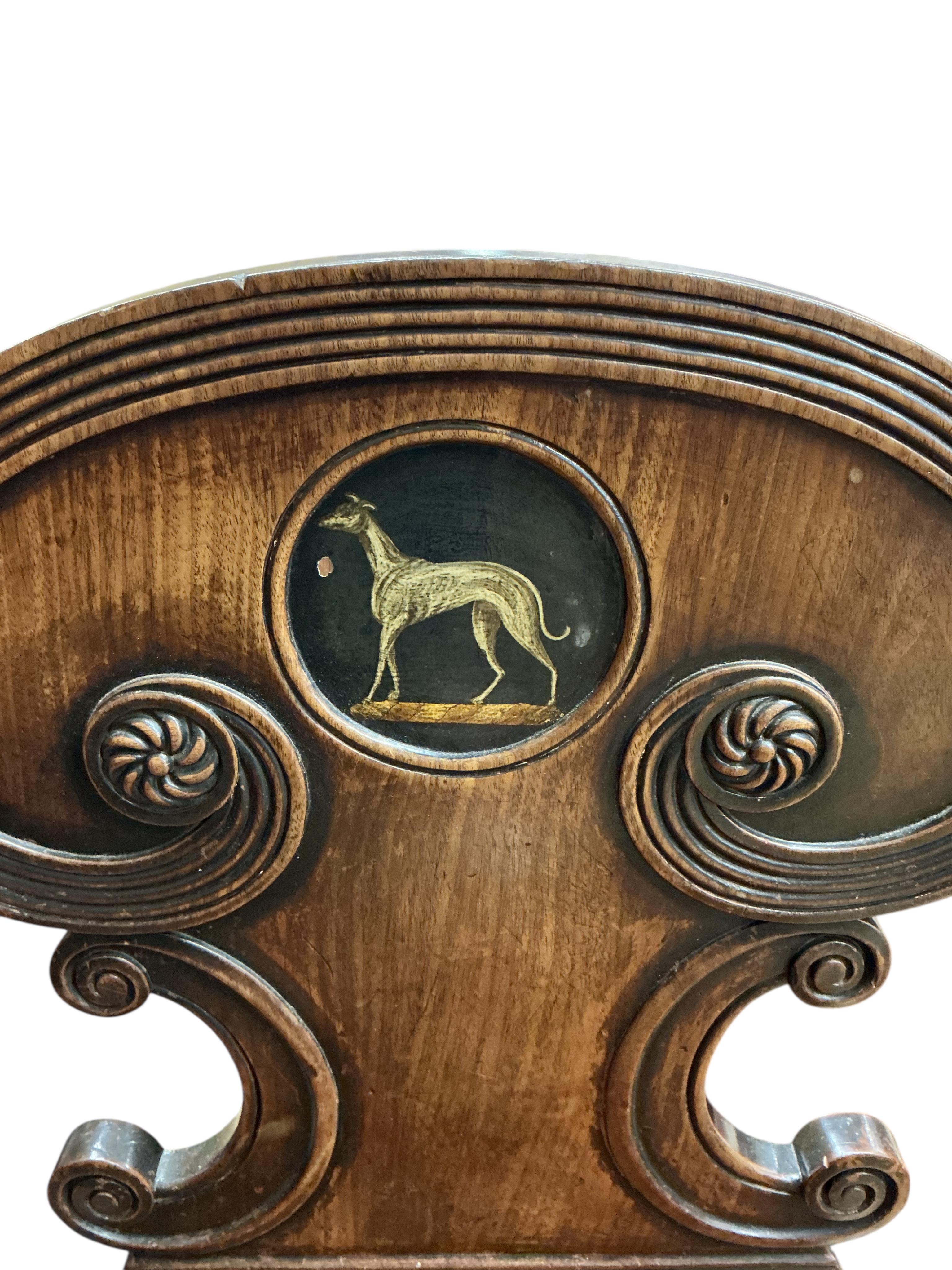 A Regency mahogany hall chair with painted greyhound armorial, height 83cm